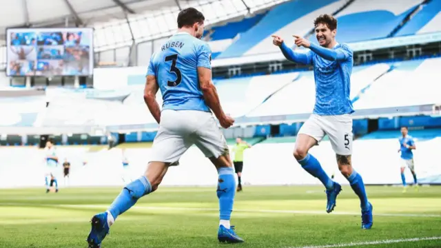 Ruben Dias and John Stones celebrate