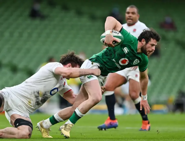 Robbie Henshaw is tackled by Tom Curry