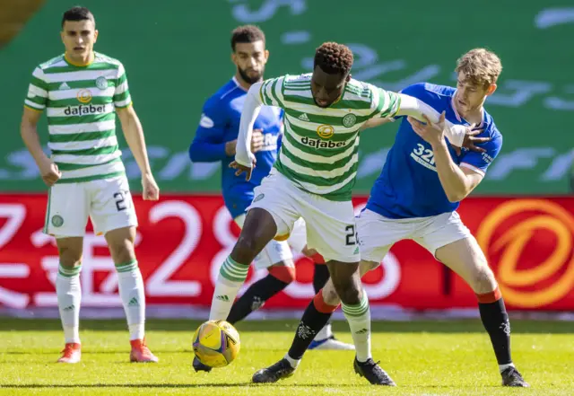 Celtic's Odsonne Edouard (left) holds off Rangers' Filip Helander