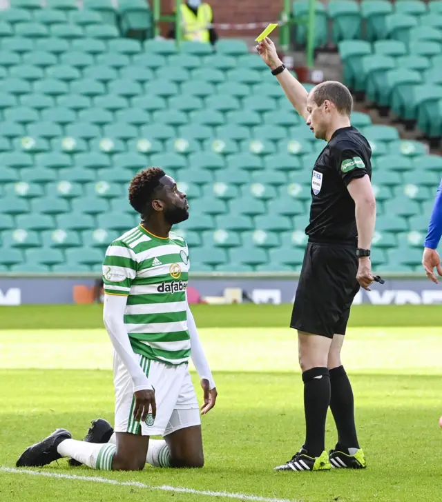 Odsonne Edouard is yellow carded by referee Willie Collum