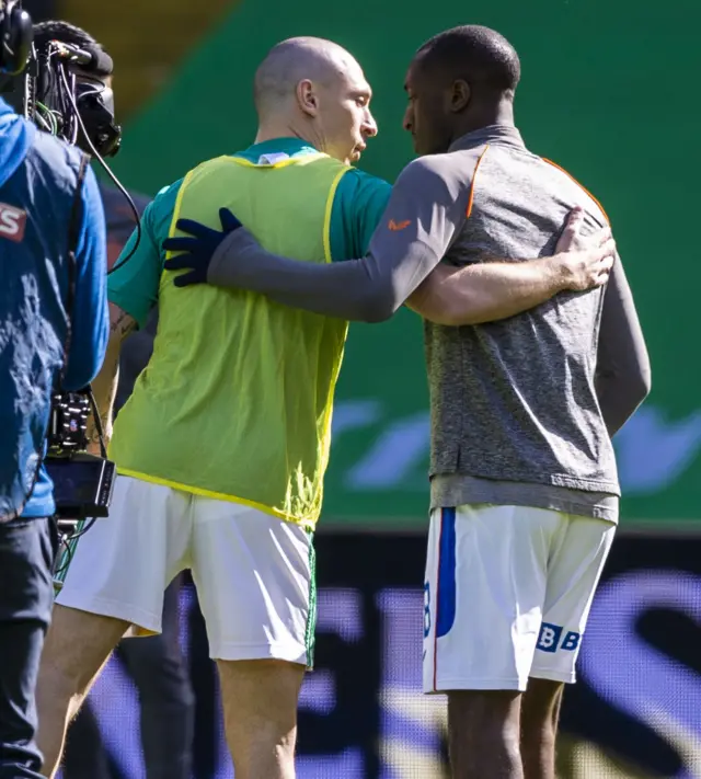 Celtic captain Scott Brown embraces Rangers' Glen Kamara