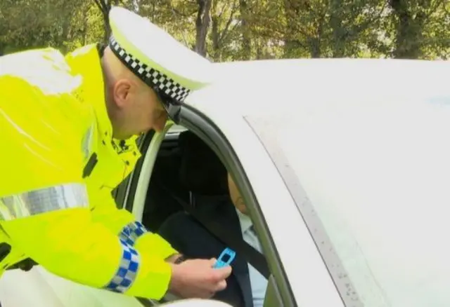 Police officer with drug testing kit