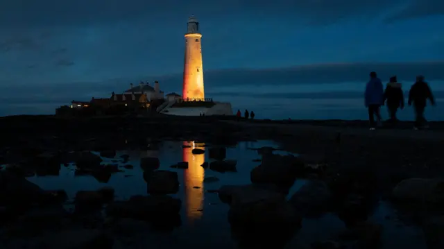 St Mary"s Lighthouse in Northumberland is illuminated yellow during the National Day of Reflection, on the anniversary of the first national lockdown to prevent the spread of coronavirus.