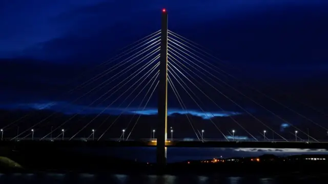 Northern Spire Bridge lit up in yellow light, as part of a day of reflection to mark the anniversary of Britain"s first coronavirus disease (COVID-19) lockdown, in in Sunderland, Britain