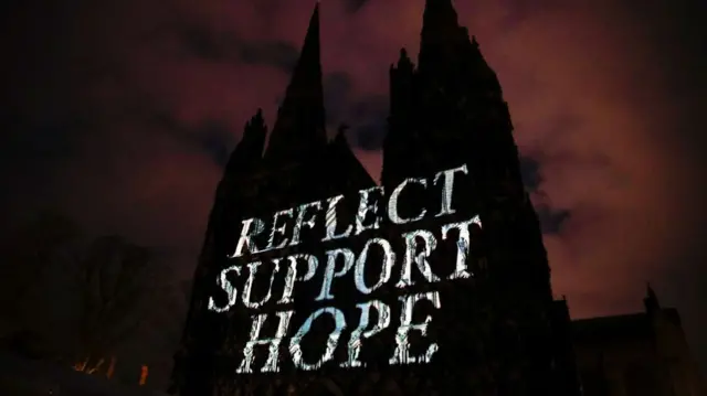 Meanwhile, the outside of Lichfield Cathedral bore the words "Reflect, Support, Hope". Inside the cathedral, candles were lit