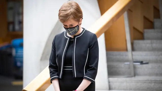 First Minister Nicola Sturgeon observes a minute"s silence in the Garden Lobby of the Scottish Parliament at Holyrood, Edinburgh, during the National Day of Reflection on the anniversary of the first national lockdown to prevent the spread of coronavirus