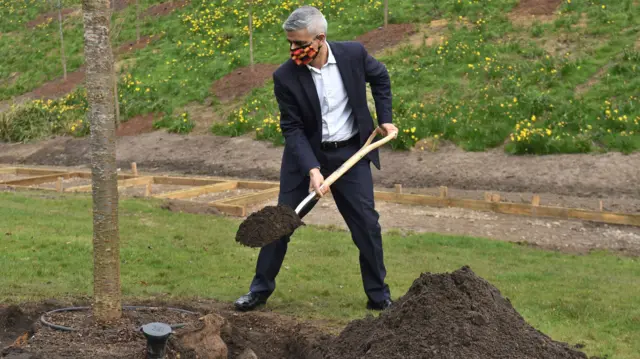 Mayor of London Sadiq Khan helps to plant the final two trees in the London Blossom Garden at Queen Elizabeth Olympic Park