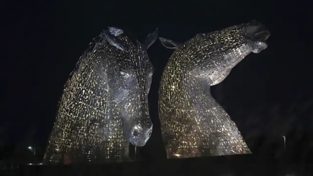 The Kelpies in Falkirk, Central Scotland, as they are lit up yellow during the National Day of Reflection, on the anniversary of the first national lockdown to prevent the spread of coronavirus.