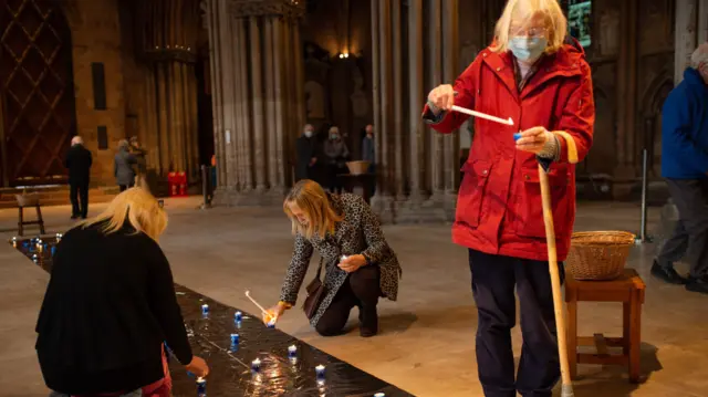 People light candles during the National Day of Reflection at Lichfield Cathedral, on the anniversary of the first national lockdown to prevent the spread of coronavirus.