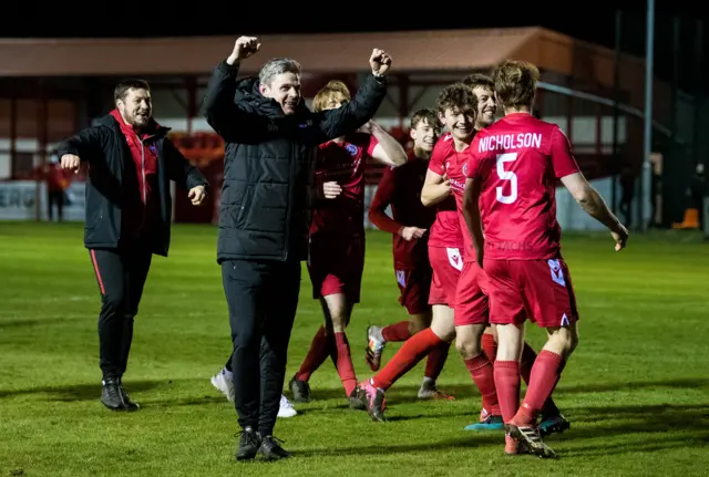 Brora players celebrate their famous win at full time