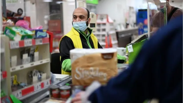 Cashier at till in shop