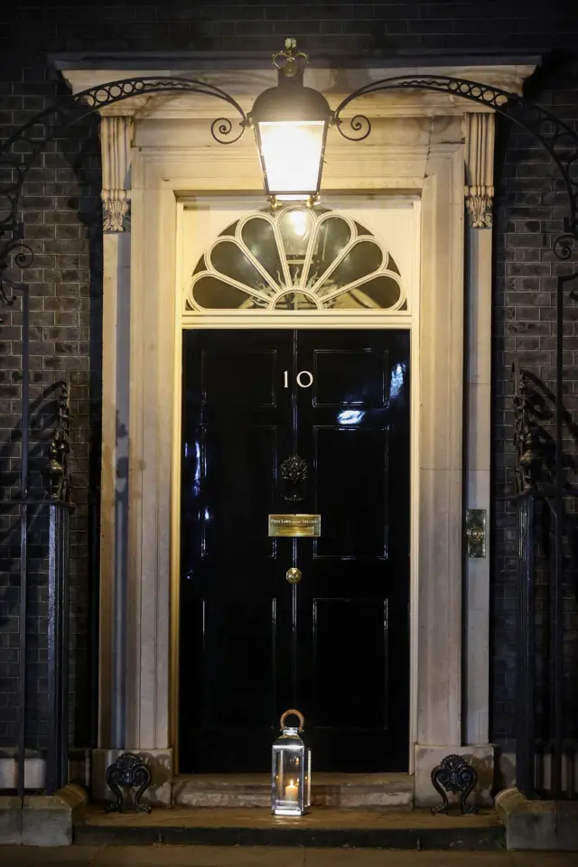 A candle is seen on the doorstep of 10 Downing Street, as part of a day of reflection to mark the anniversary of Britain"s first coronavirus disease (COVID-19) lockdown, in London, Britain March 23