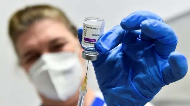 A healthcare worker prepares a dose of the AstraZeneca coronavirus disease (COVID-19) vaccine, as vaccinations resume after a brief pause in their use over concern for possible connection to blood clots, in Turin, Italy,