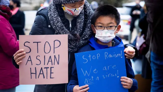 Melissa Min (L) attends a vigil with her son James in solidarity with the Asian American community after increased attacks on the community since the onset of the coronavirus pandemic a year ago, in Philadelphia, Pennsylvania,