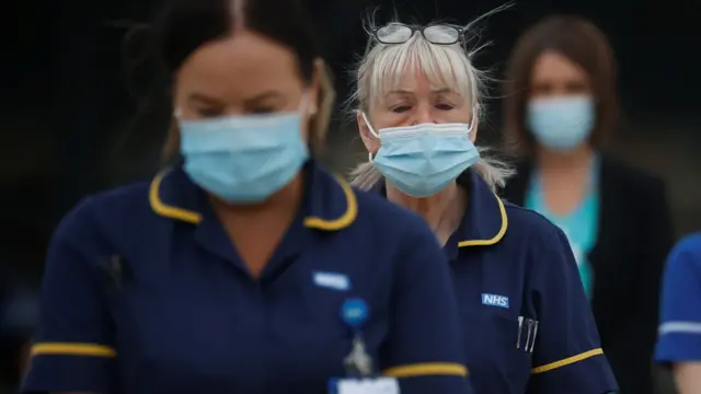 Hospital staff observe a minute's silence as part of a day of reflection