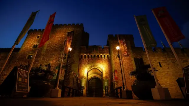 The Cardiff Castle is illuminated in yellow, as part of a day of reflection to mark the anniversary of Britain"s first coronavirus disease (COVID-19) lockdown, in Cardiff, Britain