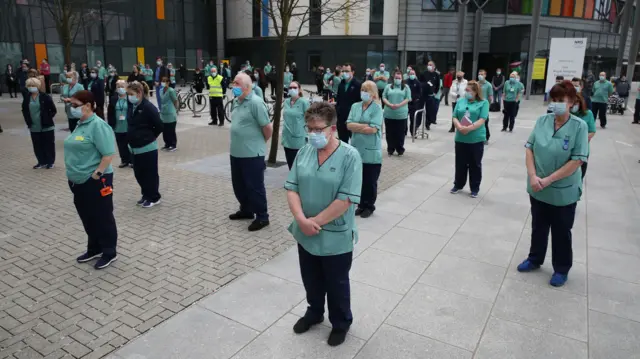 Staff observe a minute's silence