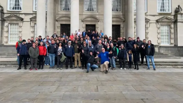 A crowd of people standing in Leeds