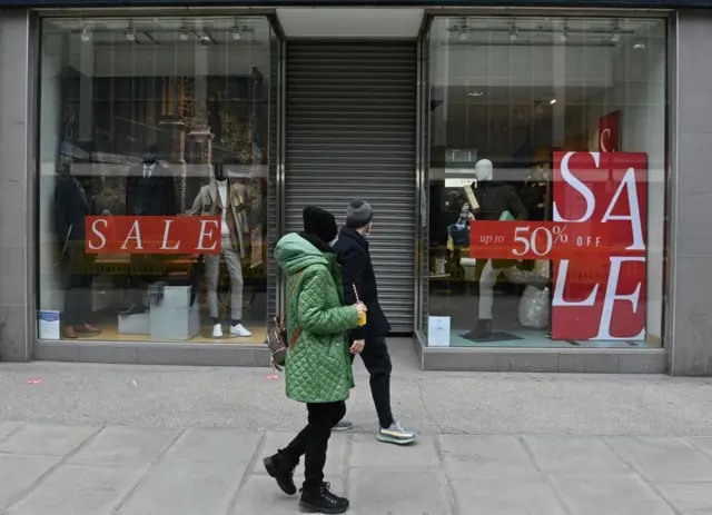 UK ighstreet shop with sale signs in window