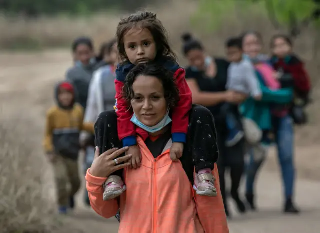 A migrant from Honduras walking to the US