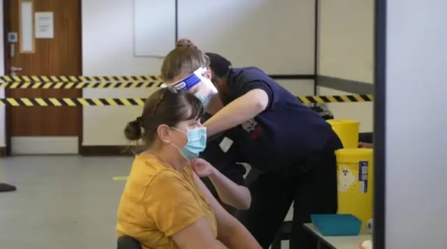 Firefighter Sophie Sinclair giving patient a Covid jab