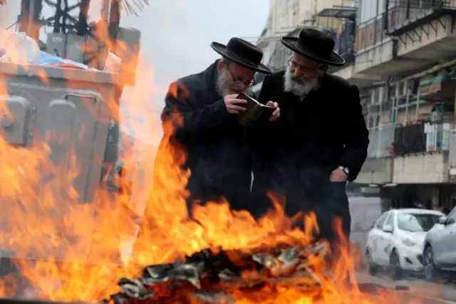 Ultra-Orthodox Jewish men burn leaven ahead of the upcoming Jewish holiday of Passover