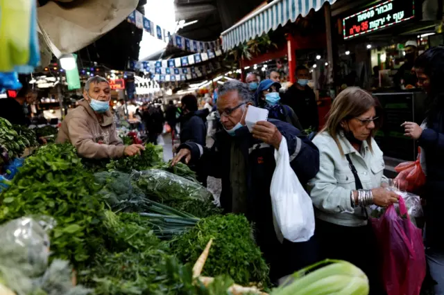 Israelis shop at a food market ahead of the upcoming Jewish holiday of Passover