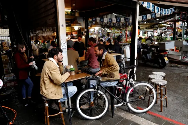 Israelis sit at a restaurant ahead of the upcoming Jewish holiday of Passover