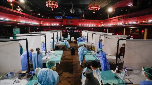 ealthcare workers prepare to collect swab samples from people, before a concert of "Love of Lesbian" that will take place this afternoon with 5,000 spectators at the Palau Sant Jordi, amid the coronavirus disease (COVID-19) pandemic, in Barcelona, Spain, March 27, 2021.