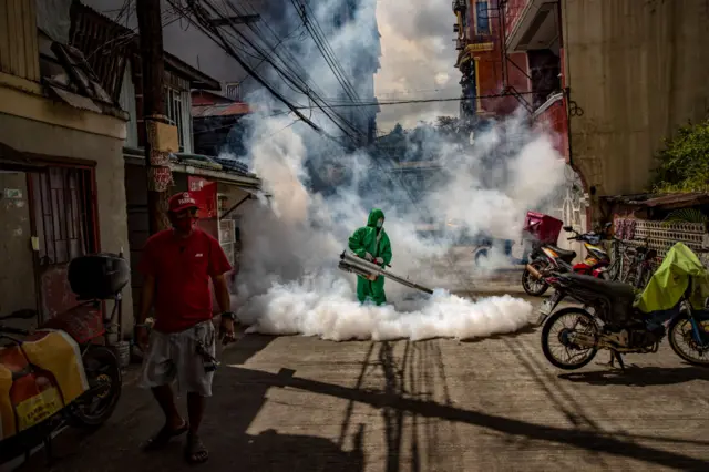 Workers have been fumigating some Manila streets during a rise in Covid infections