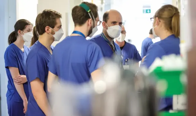 Medical professionals discuss at the intensive care unit of the University Hospital in Essen, Germany