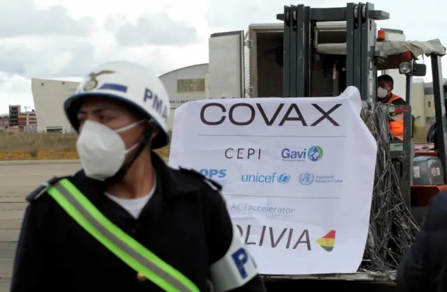 Workers unload and transport 228,000 Oxford and AstraZeneca vaccines from the Covax scheme in Bolivia