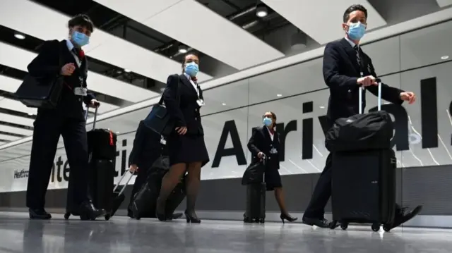 Cabin crew wear face coverings at Heathrow Airport