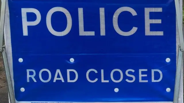 Police road closed sign