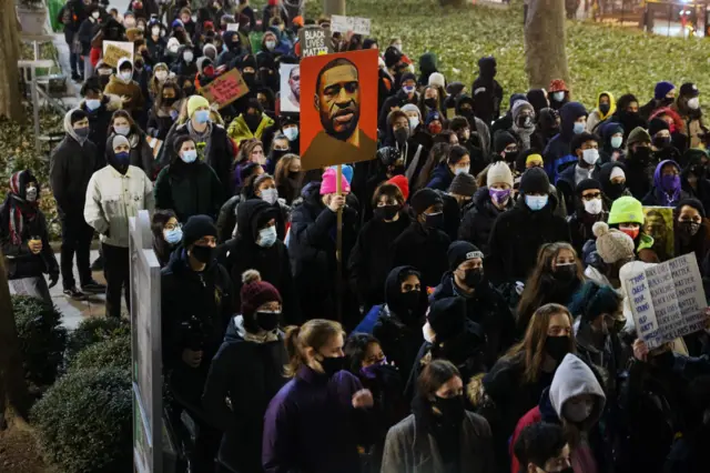 People gather in a Manhattan park to protest on the first day of the trial for the killing of George Floyd last May on March 08, 2021 in New York City