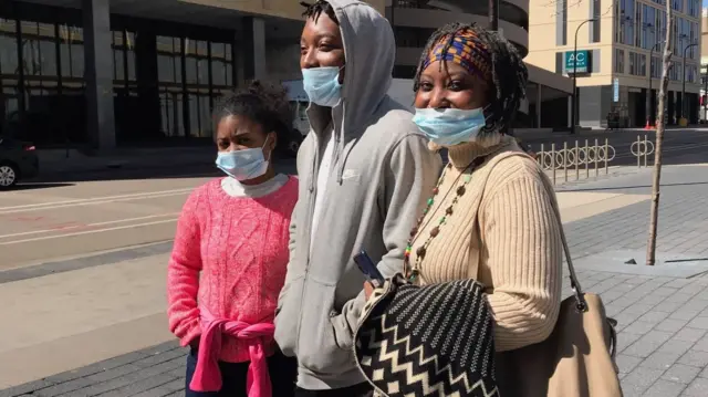 Alewanea Bey and family members follow updates outside of the court