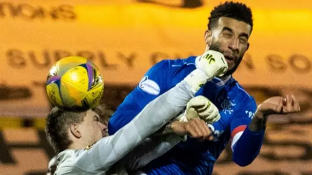 Livingston goalkeeper Max Stryjek is beaten to the ball by Connor Goldson