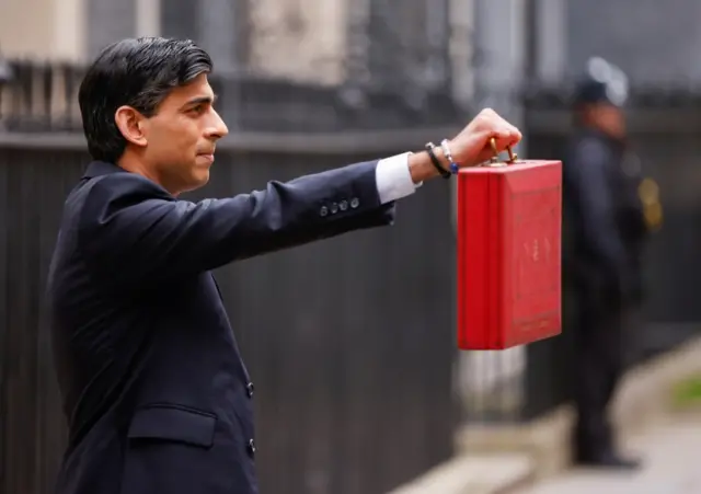 Chancellor of the Exchequer Rishi Sunak holds the Budget box outside his office in Downing Street