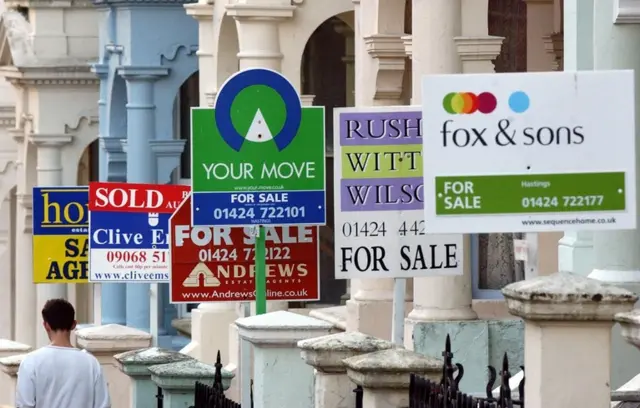 For Sale signs outside house