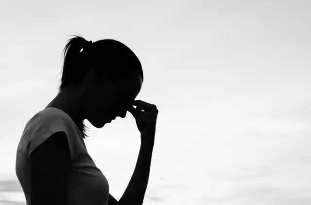 woman holding head