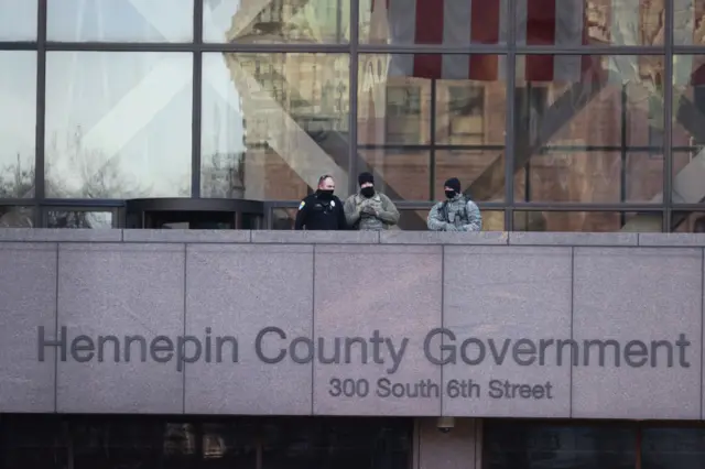 Police and National Guard soldiers stand watch at the Hennepin County Government Center before the start of the trial of former Minneapolis police officer Derek Chauvin on March 29, 2021 in Minneapolis, Minnesota