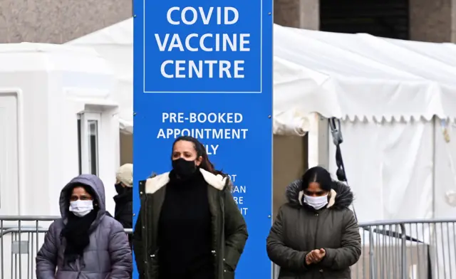 people queuing for covid vaccines