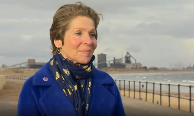 Prof Joanne Berry with Redcar's former steelworks in the background