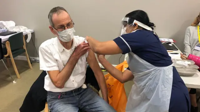 Man receiving a coronavirus vaccination