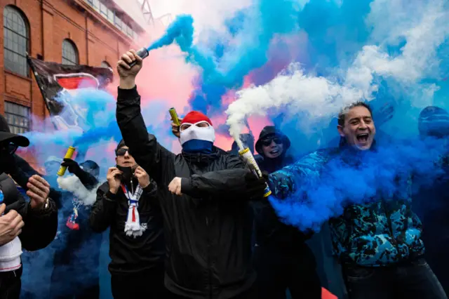 Rangers fans set off flairs outside Ibrox on Saturday morning