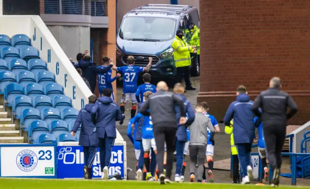 Rangers players run to greet their fans