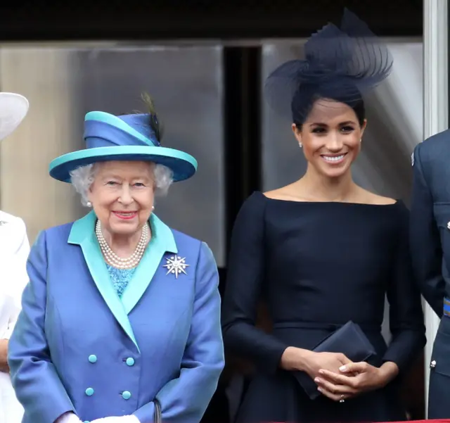 Queen Elizabeth II and Meghan, Duchess of Sussex on the balcony of Buckingham Palace as the Royal family attend events to mark the Centenary of the RAF on July 10, 2018 in London, England