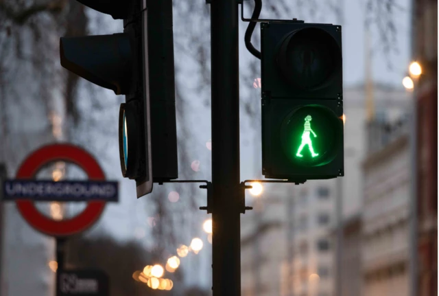 Green woman pedestrian crossing at South Kensington Tube station