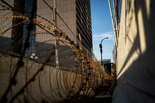 Barbed wire and fencing have gone up to protect the courthouse