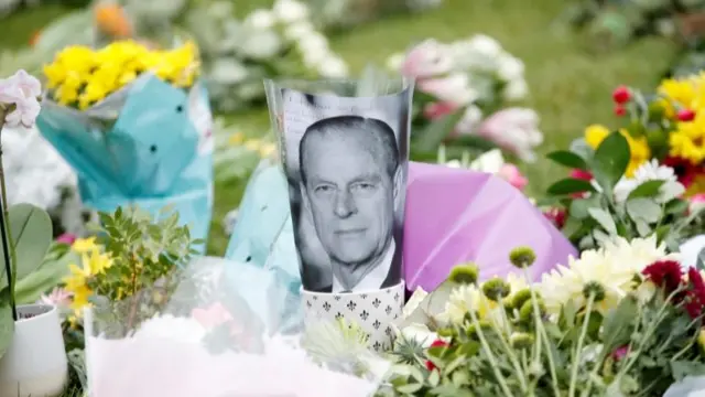 A picture of Prince Philip among flowers outside Windsor Castle